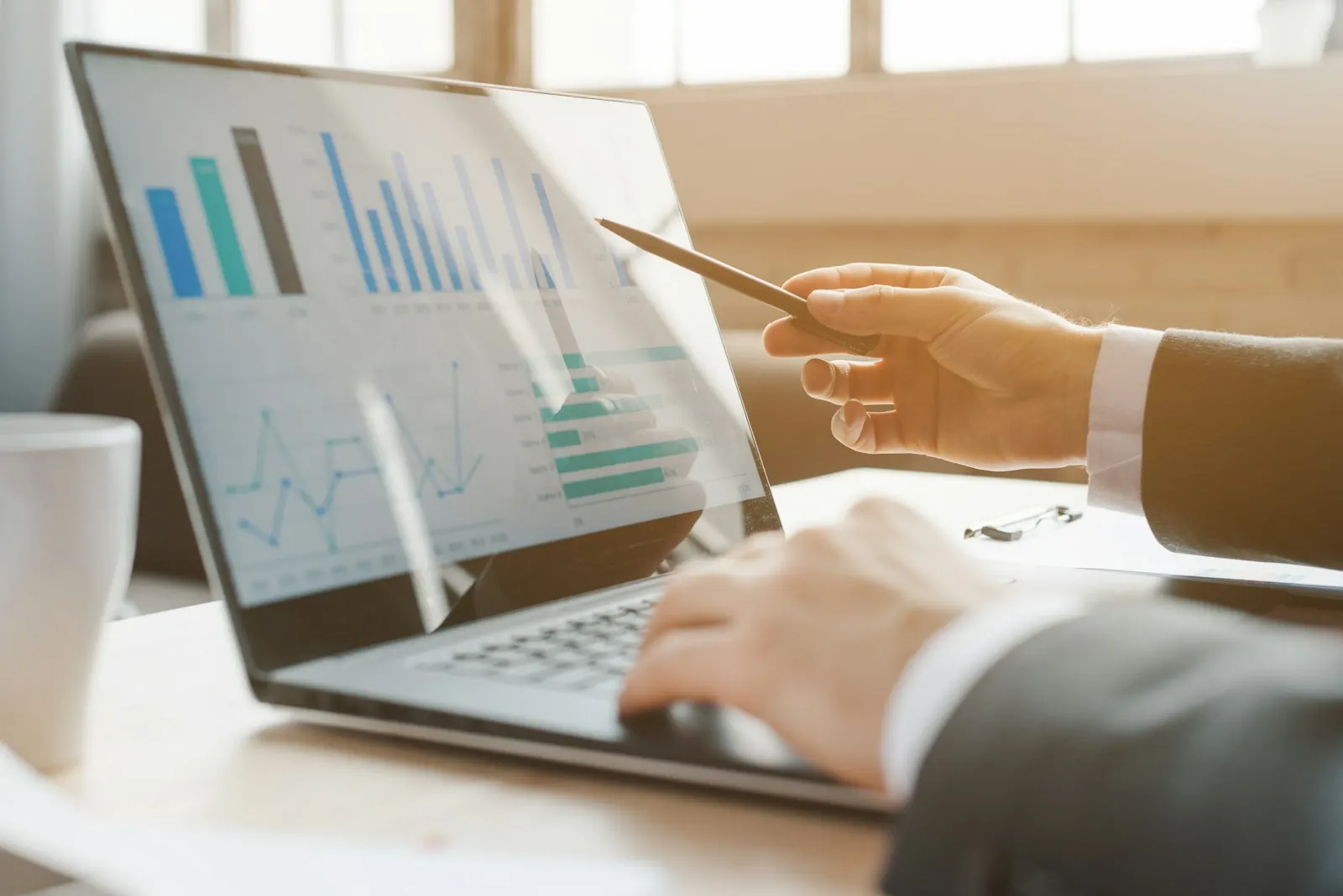 Reviewing business charts on a laptop